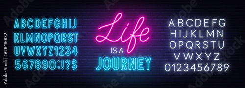 Life is a journey neon lettering on brick wall background.