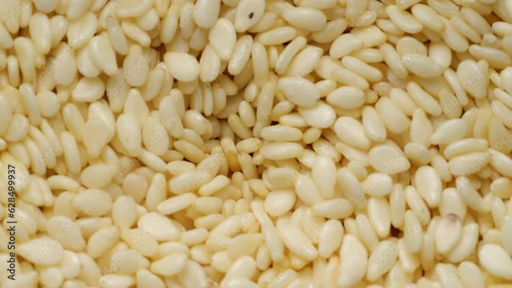 Close-up of natural dried white sesame seeds. Very close-up. Close-up of natural dried white sesame seeds. Very close-up.