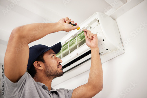 Fotografie Air conditioner, man and electrical machine repair with person in a home with ac box