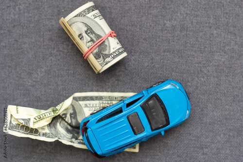 blue car model on dollar bills