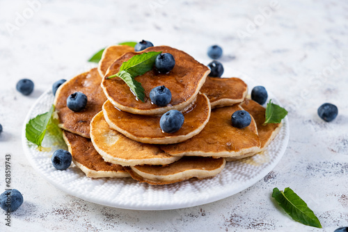 Pancakes with honey and blueberries. Sweet homemade pancakes