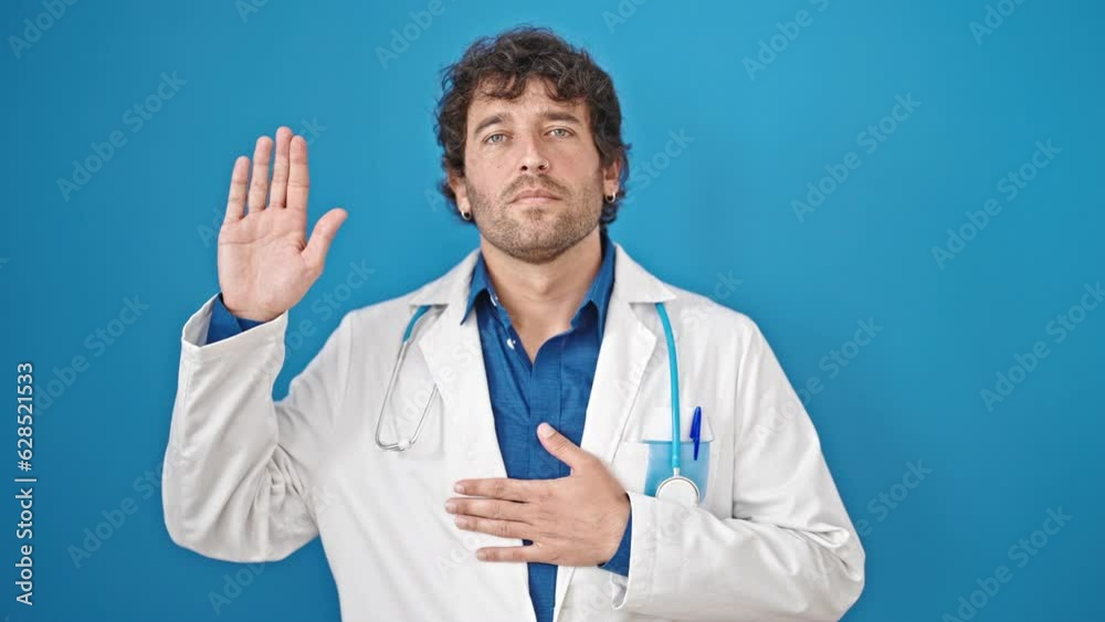 Young hispanic man doctor making an oath with hand on chest over isolated blue background Young hispanic man doctor making an oath with hand on chest over isolated blue background