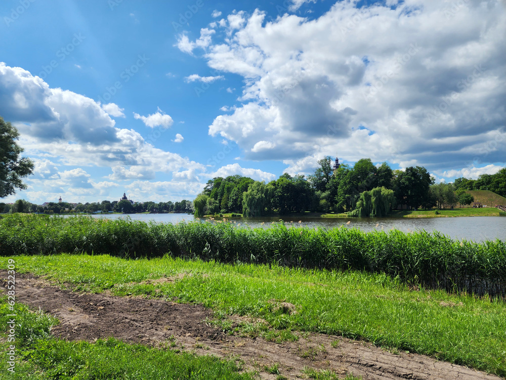 nature of Belarus. Landscape with clouds, river and green grass. Development of tourism, recreation areas in Belarus