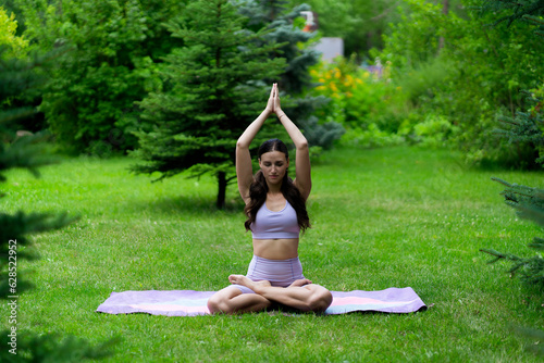 woman sitting in a lotus position, meditation outdoors, healthy relaxation