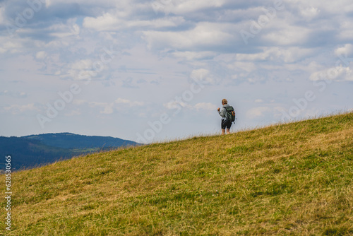 Fototapeta Naklejka Na Ścianę i Meble -  People looking from the top of the Ochodzita mountain to the Beskidy Mountains.