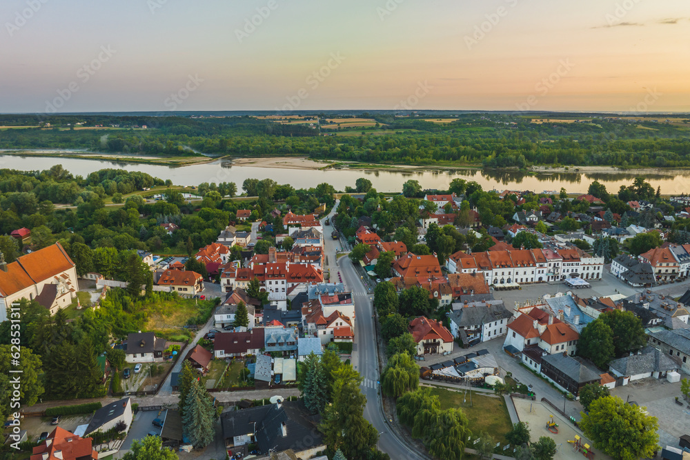View from the drone in the morning on Kazimierz Dolny. Market square, church and castle ruins.
