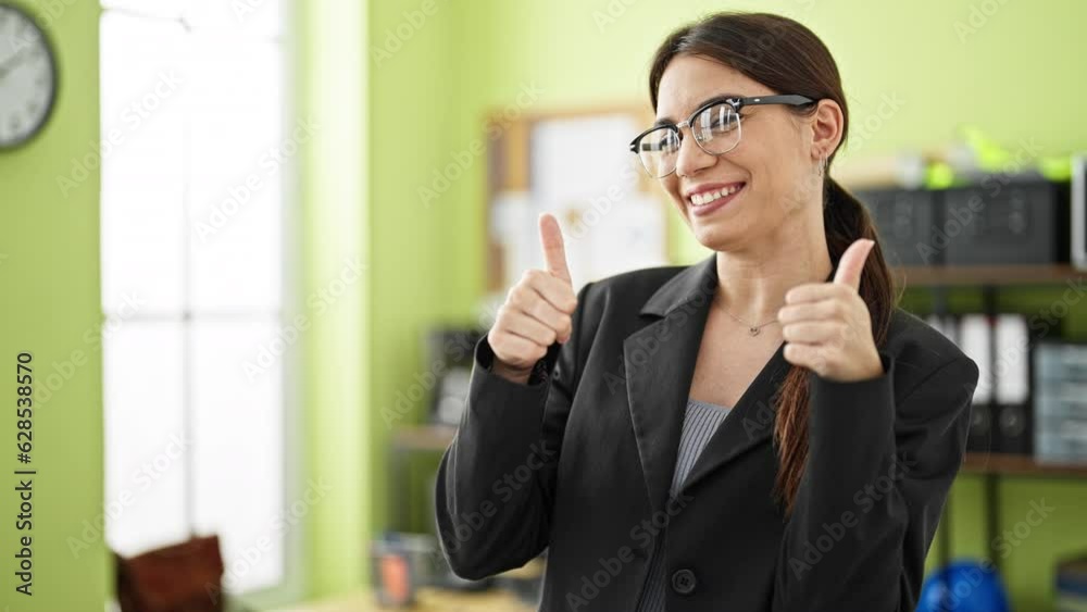 Young beautiful hispanic woman business worker pointing to camera doing thumbs up gesture at office Young beautiful hispanic woman business worker pointing to camera doing thumbs up gesture at office