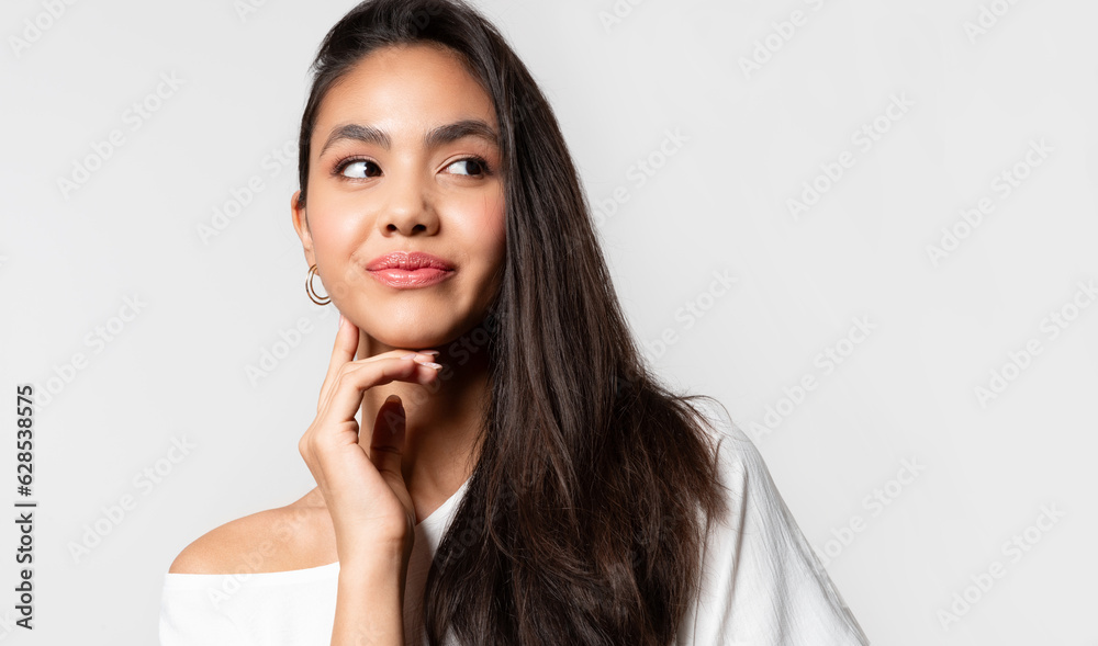 Young woman enjoy smooth skin, hair and touching cheek with hand.. Young woman enjoy smooth skin, hair and touching cheek with hand..