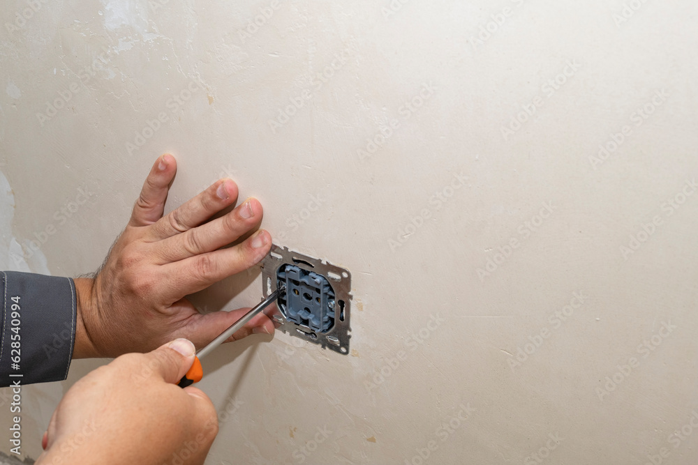 Installation of an electrical outlet in a concrete wall. Repair of the outlet. Replacement of