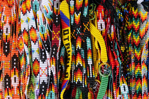 Close up of colorful beaded traditional bracelets sold at the Otavalo market, Ecuador