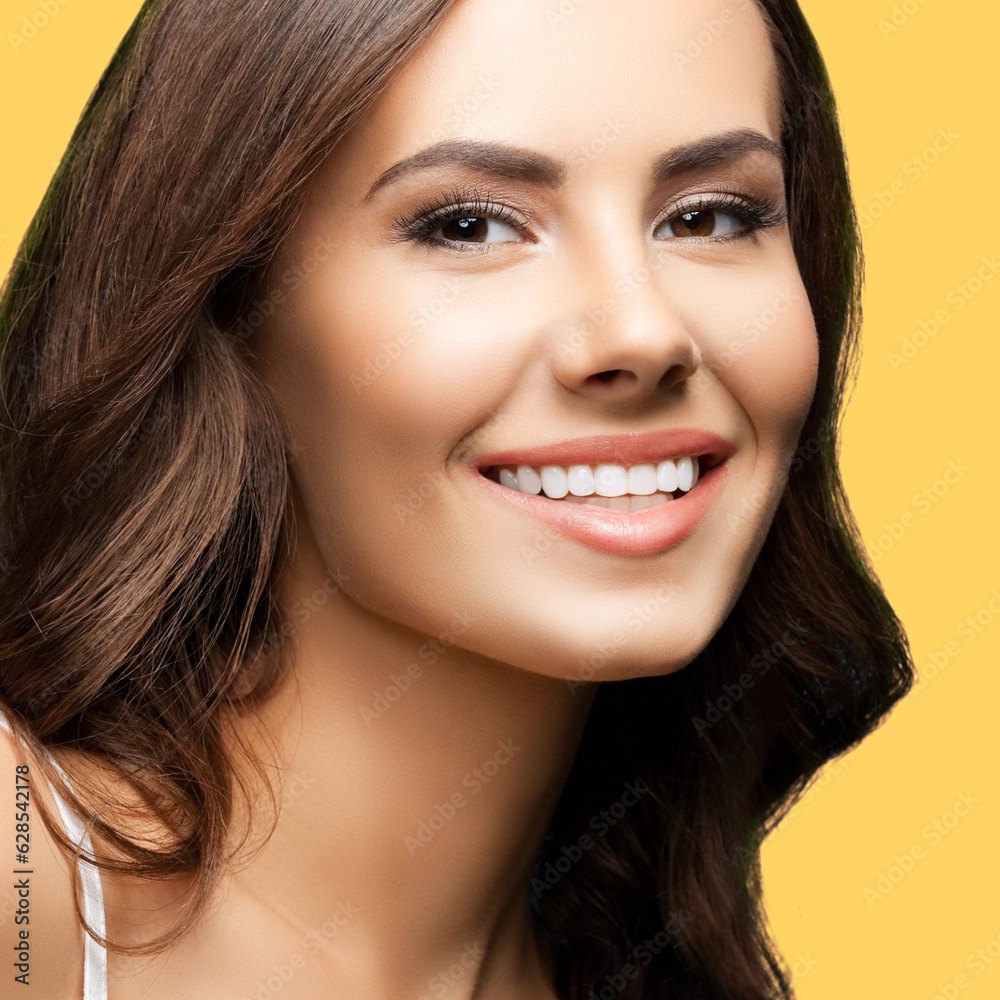 Portrait of smiling beautiful woman in white casual tank top, over yellow color background. Brunette girl at studio concept. Square composition. Portrait of smiling beautiful woman in white casual tank top, over yellow color background. Brunette girl at studio concept. Square composition.