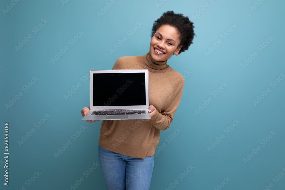 young happy latin business woman with curly hair holding laptop with mockup and isolated studio background with copy space young happy latin business woman with curly hair holding laptop with mockup and isolated studio background with copy space