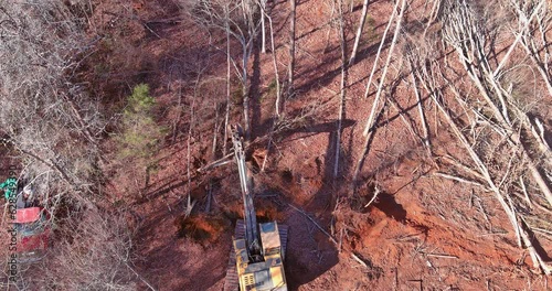  Removal stump roots from trees which were cut down to clear land for home construction was done with tractor backhoe.