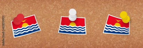 Kiribati flag pinned in cork board, three versions of Kiribati flag.