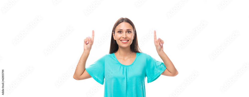 young pretty european woman with dark long hair dressed in a blue t-shirt points with her hands to the free space to insert advertising and text young pretty european woman with dark long hair dressed in a blue t-shirt points with her hands to the free space to insert advertising and text