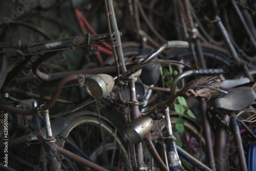 Stack of vintage rusty bicycles in the workshop