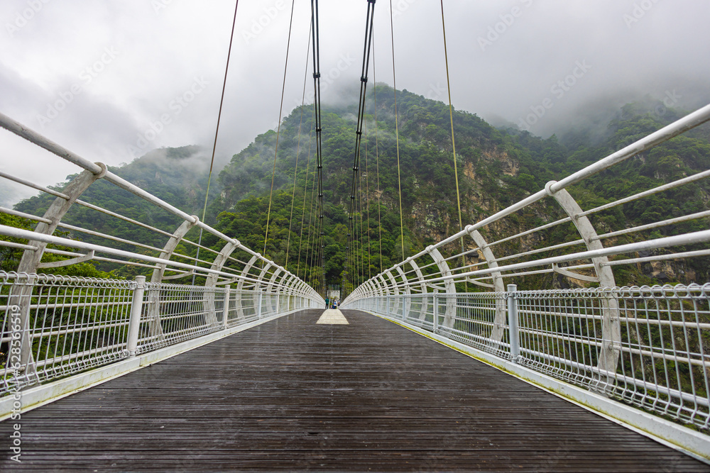 Obraz premium Blow Bay Suspension Bridge or Mountain Moon bridge. A impressive breathtaking suspension bridge in the Taroko National park. View from the Buluowan Terrace Observation Deck. Taiwan landscape Nature