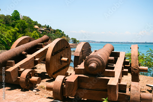 Two old vintage cannons on the candolim beach at Goa, India. selective focus. photo