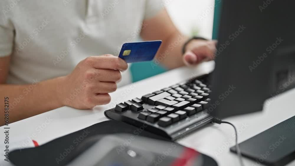 Grey-haired man business worker shopping with computer and credit card at the office Grey-haired man business worker shopping with computer and credit card at the office