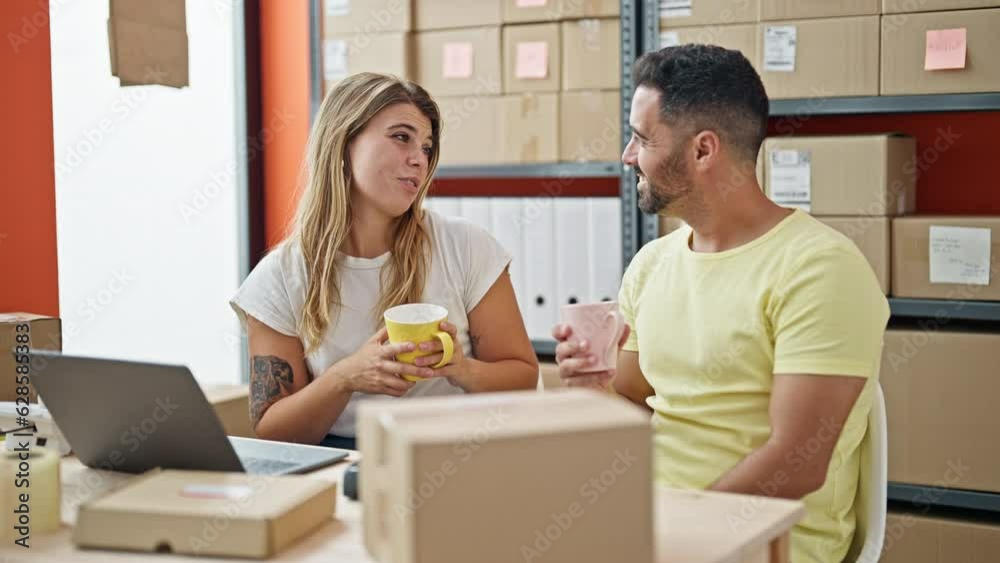 Man and woman ecommerce business workers drinking coffee smiling at office Man and woman ecommerce business workers drinking coffee smiling at office