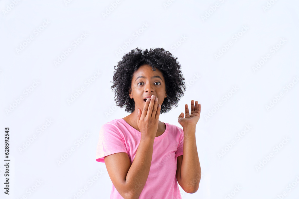 colombian girl with afro hair surprised with hand on mouth in pink t-shirt on white background colombian girl with afro hair surprised with hand on mouth in pink t-shirt on white background