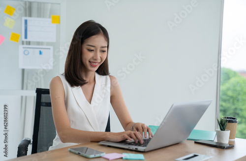 asian beautiful woman working at office © Thongden_studio