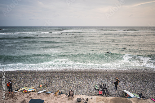 Lima, Peru - June 1, 2022. View of the surfers waiting the waves of the Pacific ocean photo