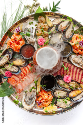 Fresh seafood plate with mussels, oysters, scallop and tuna