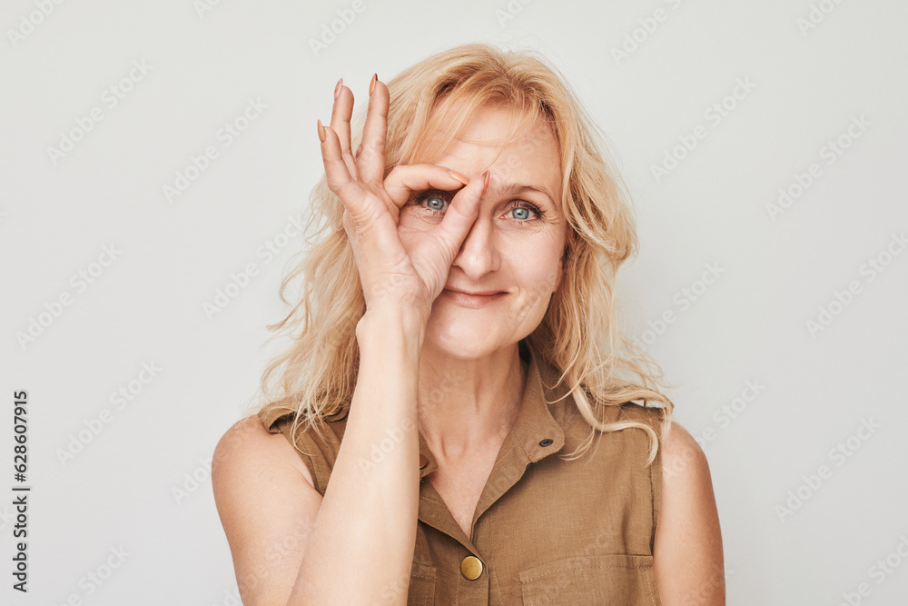 Portrait of adult woman showing OK sign with fingers isolated on white background. Successful career, accepted concept Portrait of adult woman showing OK sign with fingers isolated on white background. Successful career, accepted concept