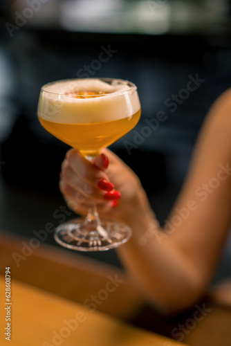 close-up of bar customer's hands holding alcoholic cocktail a drinks concepts in bar or club