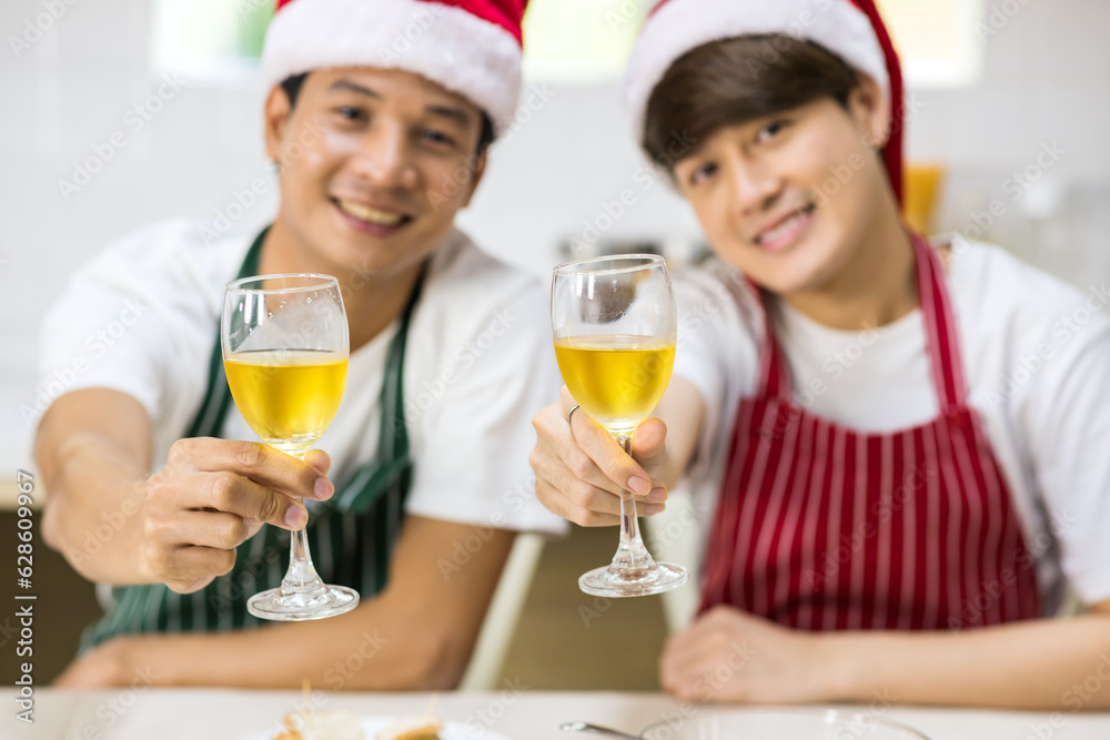 Young LGBT Asian gay couple toast glasses of champagne Young LGBT Asian gay couple toast glasses of champagne
