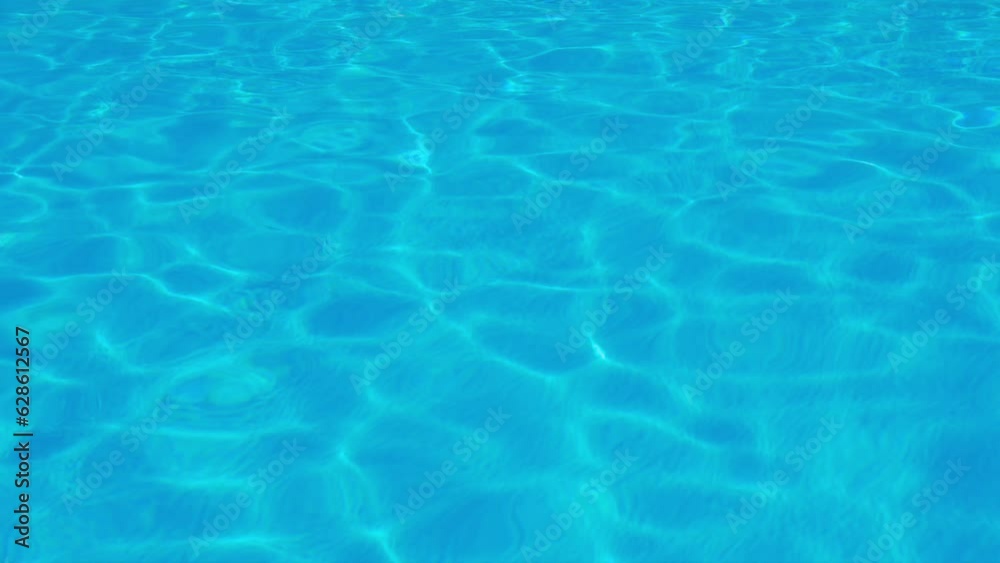 Blue Water in Glare and Sun Reflections from Ocean Sea Swimming Pool. Blue Surface Water Texture in Sunlight. Abstract background. Relax, Beauty. Vacation, travel. Blue Water in Glare and Sun Reflections from Ocean Sea Swimming Pool. Blue Surface Water Texture in Sunlight. Abstract background. Relax, Beauty. Vacation, travel.