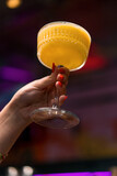 close-up of bar customer's hands holding alcoholic cocktail drinks concepts in a bar or club