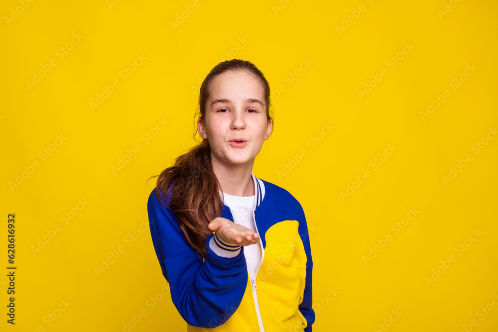 promotion and sale of sports goods, girl in sports wear in Ukrainian flag colors over yellow background promotion and sale of sports goods, girl in sports wear in Ukrainian flag colors over yellow background
