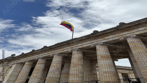 facade of the Senate of the Republic of Colombia with the flag waving in the center of Bogotá