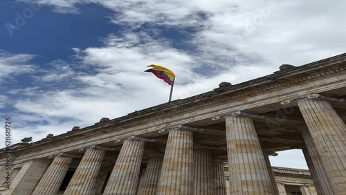 facade of the Senate of the Republic of Colombia with the flag waving in the center of Bogotá