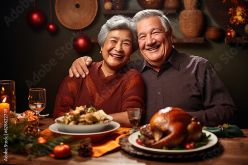 Portrait of couple of seniors having dinner with turkey celebrating Thanksgiving Day.