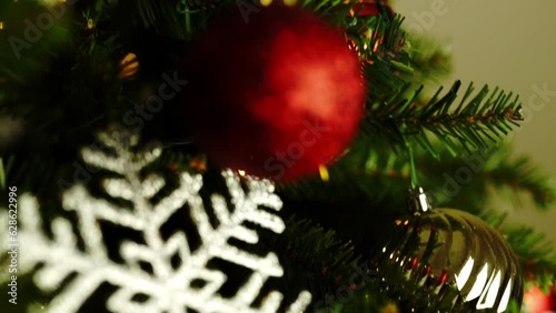Slow motion. View of a Christmas tree decorated with colorful balls