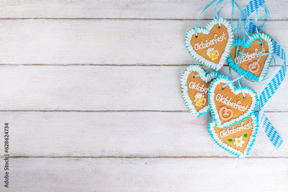 Background for Oktoberfest invitation, menu, greeting card, White wooden table or wall empty surface with checkered ribbon and heart cookies with Oktoberfest symbols - flower, beer, pretzel top view Background for Oktoberfest invitation, menu, greeting card, White wooden table or wall empty surface with checkered ribbon and heart cookies with Oktoberfest symbols - flower, beer, pretzel top view