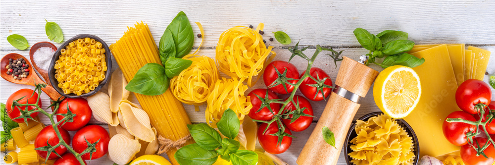 Various pasta with spices and ingredients for cooking. Preparation dinner, lunch background with fresh basil, tomatoes, spices, garlic and different sort and types of italian Mediterranean pasta Various pasta with spices and ingredients for cooking. Preparation dinner, lunch background with fresh basil, tomatoes, spices, garlic and different sort and types of italian Mediterranean pasta