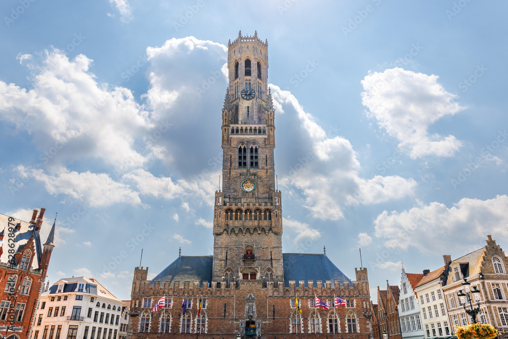 Fototapeta premium The Belfry of Bruges, a medieval bell tower in the centre of Bruges, Belgium. One of the city's most prominent symbols, the belfry formerly housed a treasury and the municipal archives