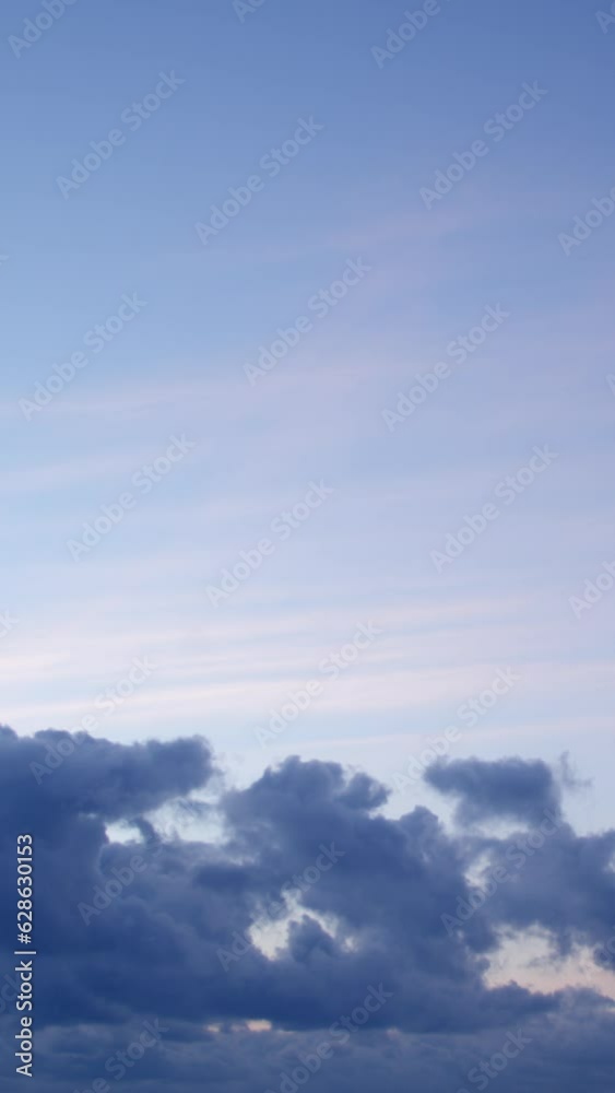 The calm and serene sky serves as a perfect backdrop to the soft and gentle clouds in this mesmerizing video timelapse of the blue hour. Vertical video. The calm and serene sky serves as a perfect backdrop to the soft and gentle clouds in this mesmerizing video timelapse of the blue hour. Vertical video.
