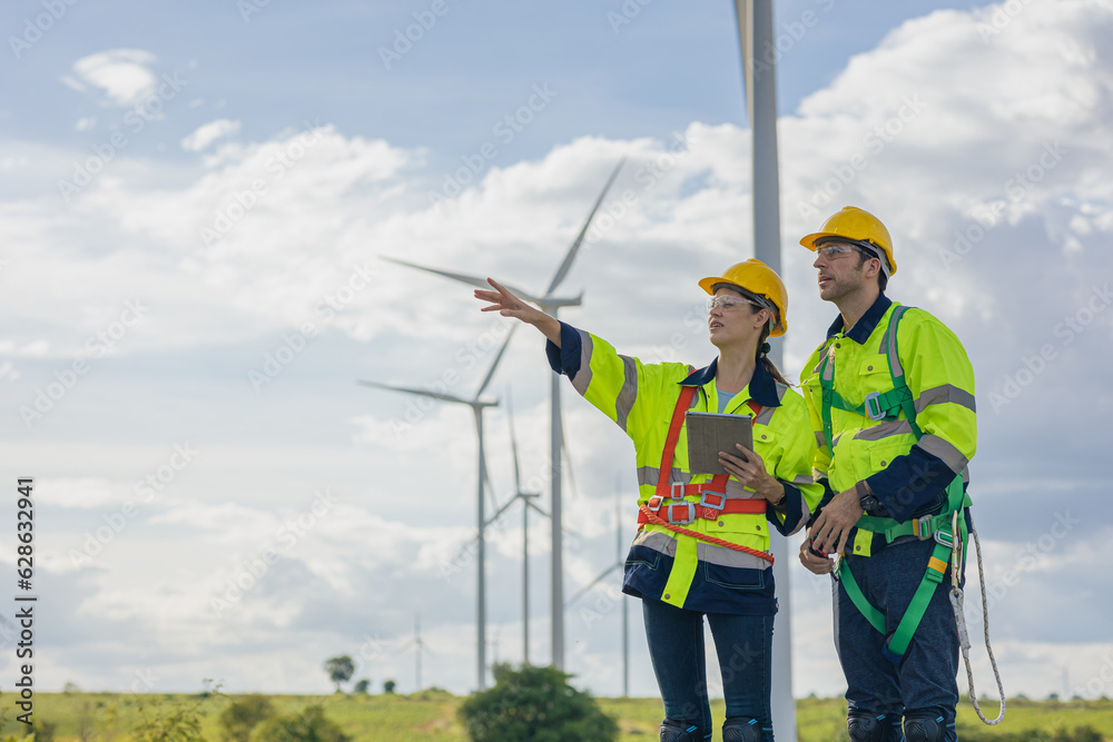 Engineer team man and woman field working together survey plan construction wind turbine clean power generator Engineer team man and woman field working together survey plan construction wind turbine clean power generator