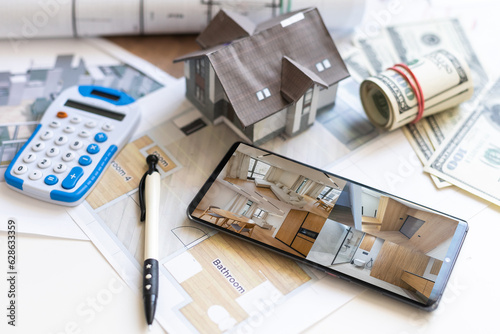 Blueprints, house model, notebook and pen on the table - architecture and real estate concepts