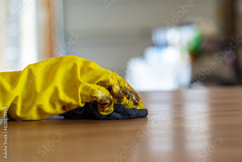 Refinishing a mid century modern table top coat. Stripping with furniture refinisher, steel wool and yellow rubber gloves.
