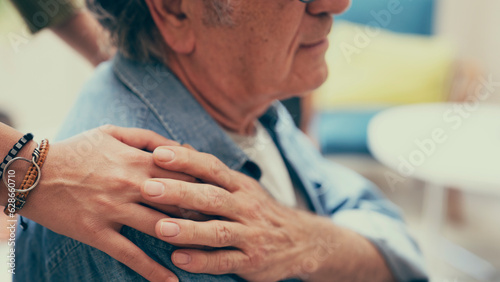 Comforting hand on shoulder of man