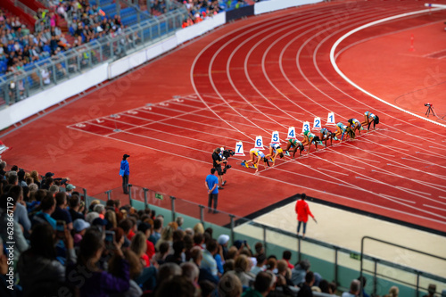 Female Sprinters at the start line of the 100 meters sprint race. Track and Field photo for Summer Game in Paris