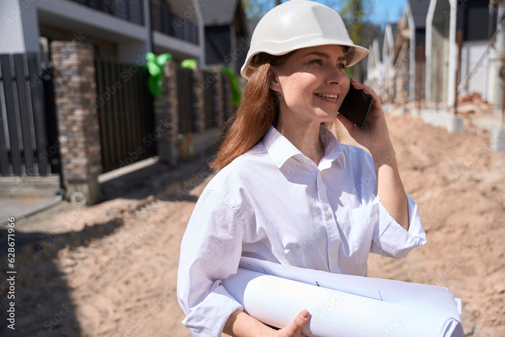 Cheerful woman landscape designer talking to phone Cheerful woman landscape designer talking to phone
