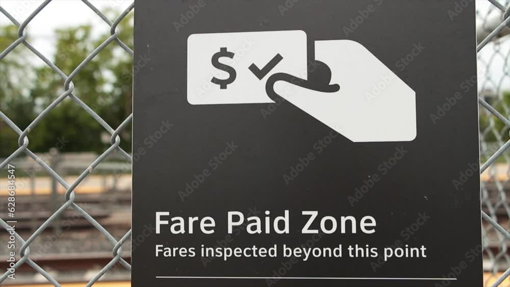 fare paid zone fares inpected beyond this point caption sign in white