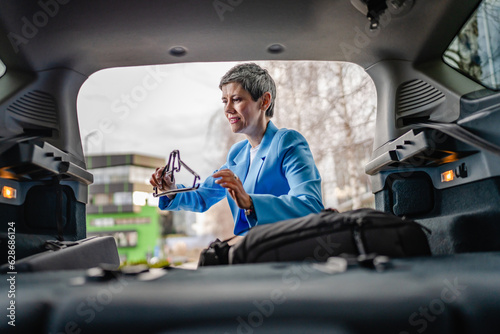 one senior woman pack luggage baggage suitcase in the trunk of the car © Miljan Živković